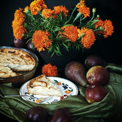 orange and green flowers on brown wooden round tray